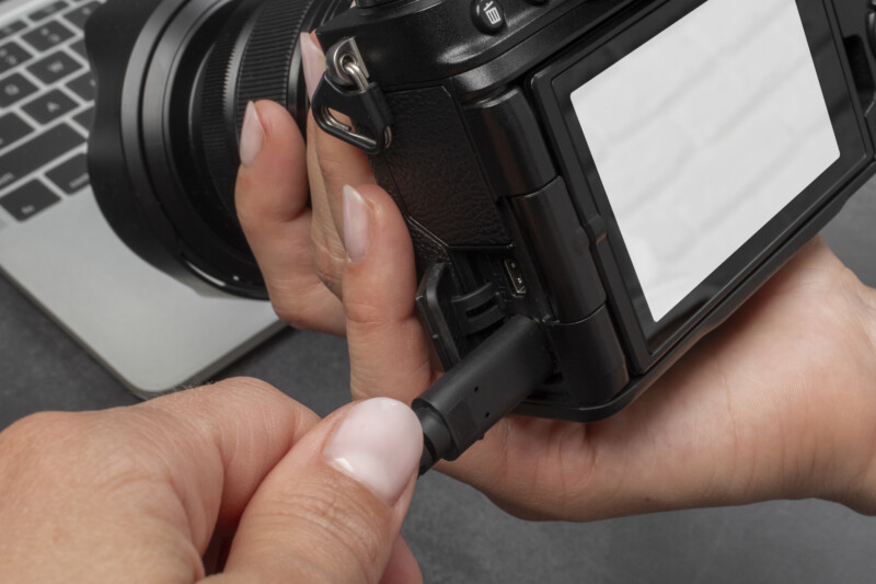 high angle hands holding photo camera