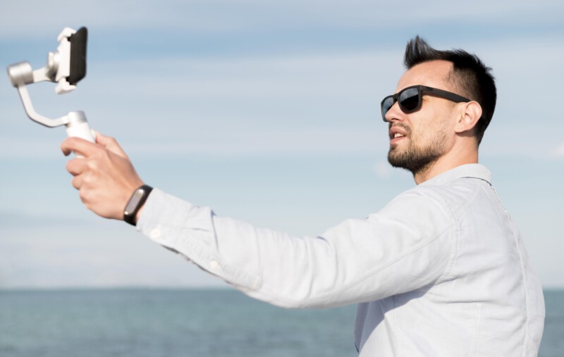 man with sunglasses recording himself
